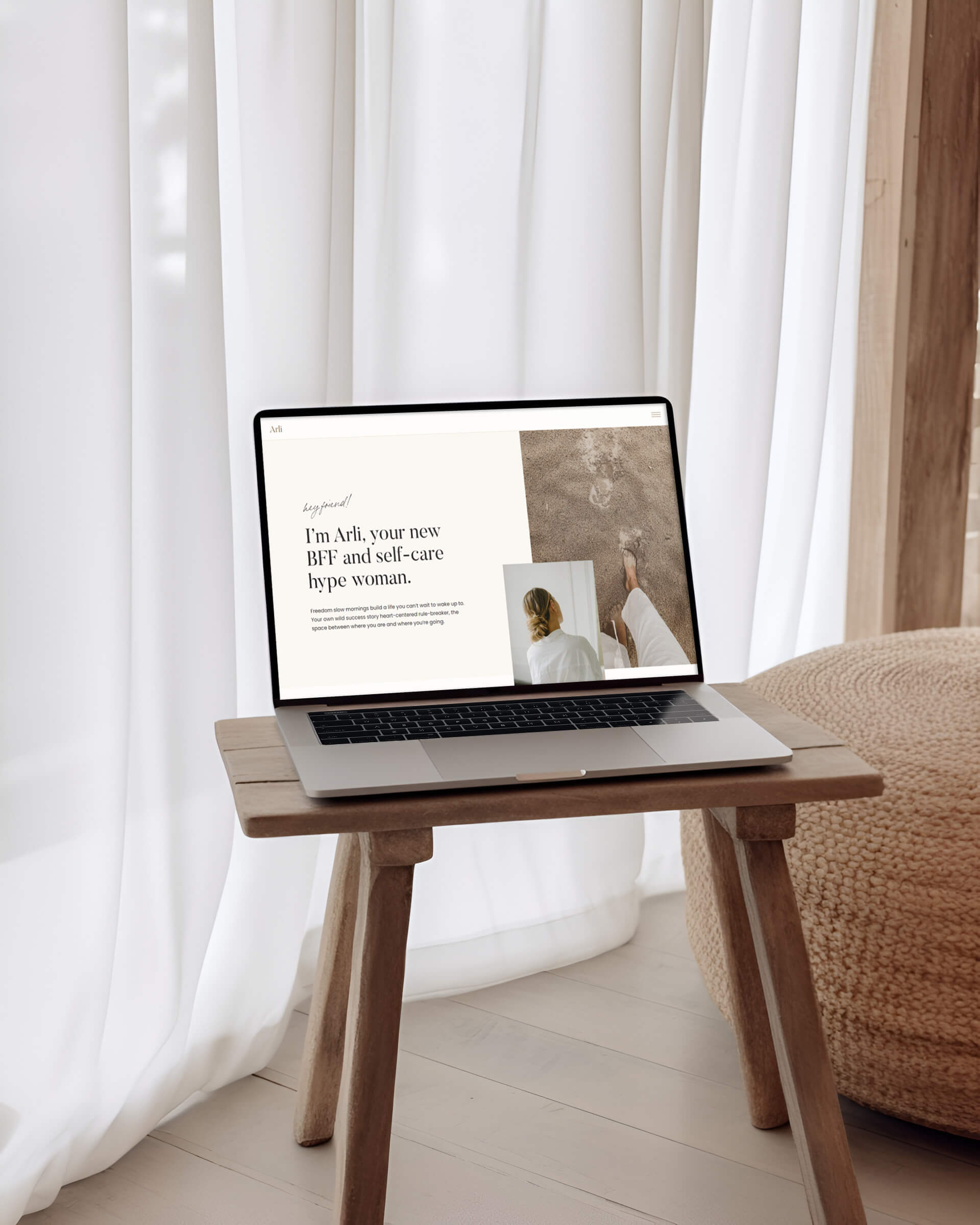 A mockup of the Arli Website Template in a macbook on a wooden chair